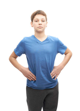 Serious and focused young boy in a blue t-shirt, portrait isolated over the white backgroundの写真素材