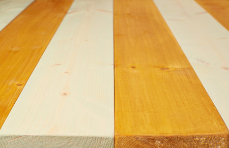 Colorful paint coated pine wood boards fragment as a background composition with a shallow depth of...