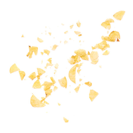 Potato chips crumbs and leftovers isolated over the white backgroundの写真素材