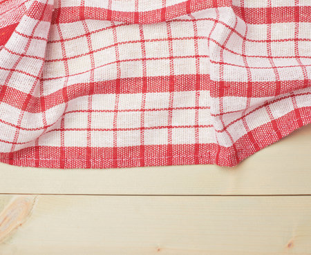 Red tablecloth or towel over the surface of a wooden table