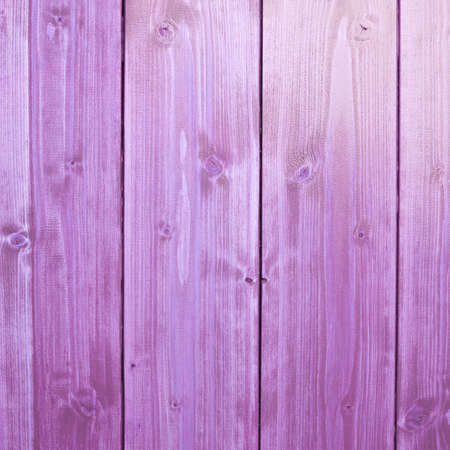 Violet paint coated wooden pine boards lying in a row as a close-up background compositionの写真素材