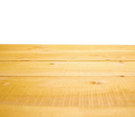 Yellow paint coated wooden pine boards as a copyspace background composition isolated over the white backgroundの写真素材