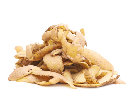 Pile of brown potato peels isolated over the white background