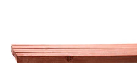 Red paint coated wooden pine boards as a copyspace background composition isolated over the white backgroundの写真素材