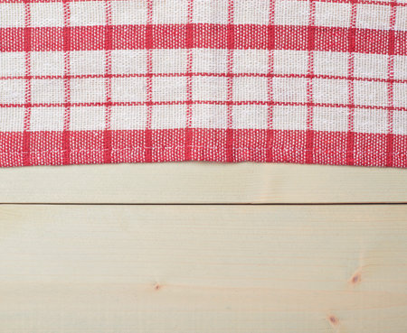 Red tablecloth or towel over the surface of a wooden tableの写真素材