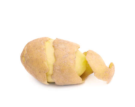 Half peeled potato with the twirling skin peel over it, composition isolated over the white の写真素材