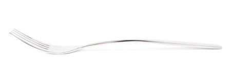 Stainless steel glossy kitchen metal fork isolated over the white background, side view foreshoteningの写真素材