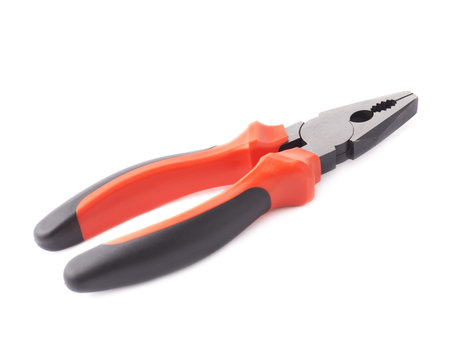 Metal pliers tool with the black and red plastic handle isolated over the white backgroundの写真素材