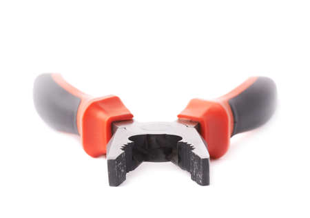 Metal pliers tool with the black and red plastic handle isolated over the white backgroundの写真素材