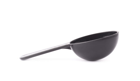 Black plastic measure small spoon isolated over the white の写真素材