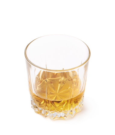 Glass tumbler filled with whiskey bourbon isolated over the white backgroundの写真素材