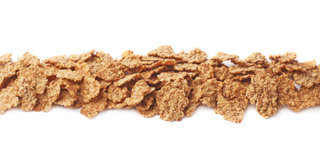 Whole grain cereal flakes aligned in a line, composition isolated over the white background