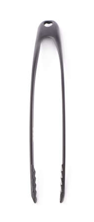 Kitchen salat serving black plastic pair of tongs isolated over the white backgroundの写真素材