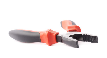 Metal pliers tool with the black and red plastic handle isolated over the white background