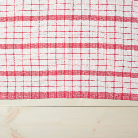 Red tablecloth or towel over the surface of a wooden table