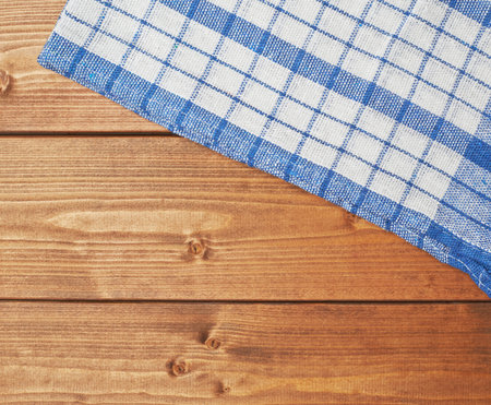Blue tablecloth or towel over the surface of a brown wooden table