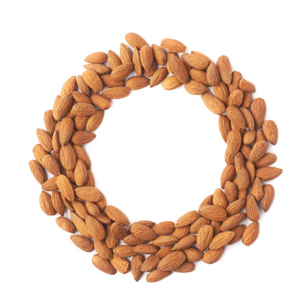 Round frame circle made of almond seeds isolated over the white backgroundの写真素材