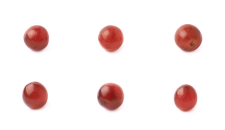 Six single dark red grapes isolated over the white backgroundの写真素材