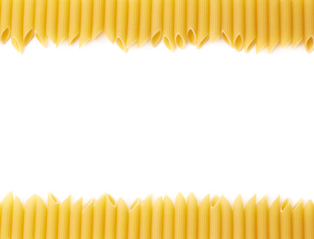 Dried penne pasta copyspace and empty for text background composition over the white surfaceの写真素材