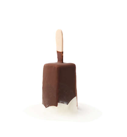 Melting chocolate covered vanilla ice cream bar on a wooden stick in a puddle of melt ice-cream, composition isolated over the white backgroundの写真素材