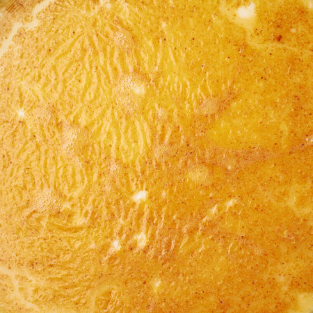 Half cooked scrambled eggs omelette close-up texture fragment