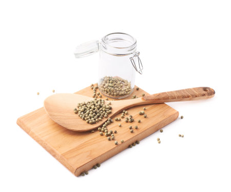 Green peppercorn, glass jar, wooden spoon and board composition isolated over the white backgroundの写真素材