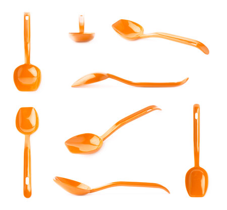 Orange glossy plastic kitchen cooking scoop isolated over the white backgroundの写真素材