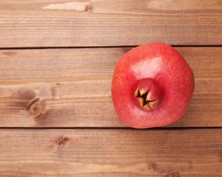 Pomegranate Punica granatum fruit composition placed over the wooden boards surfaceの写真素材
