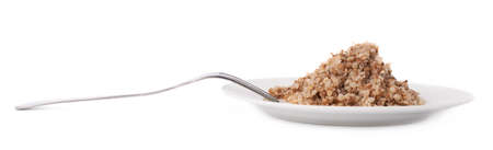 Cooked buckwheat seeds served on a white ceramic plate, composition isolated over the white backgroundの写真素材