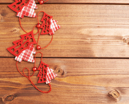 Christmas tree garland over the wooden surface as a festive background compositionの写真素材