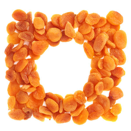 Round shape made of dried orange apricots over isolated white background, top viewの写真素材
