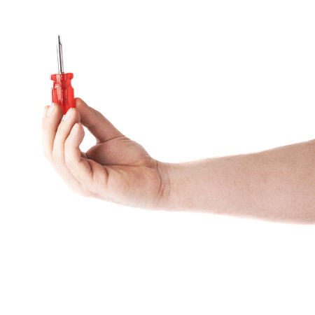 Worker's caucasian male hand holding a screwdriver  tool, composition isolated over the white backgroundの写真素材