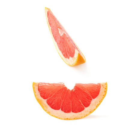 Slice section of ripe grapefruit isolated over the white backgroundの写真素材