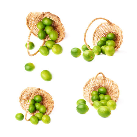 Wicker basket full of multiple ripe green limes, composition isolated over the white background, set of four different foreshorteningsの写真素材