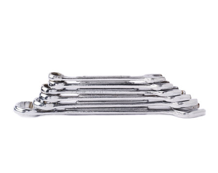 Stack of wrenchs metal spanner instruments isolated over white background