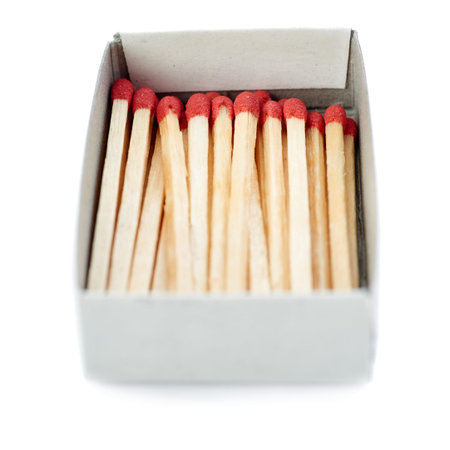 Pile of Wooden unused matches in box isolated over the white background