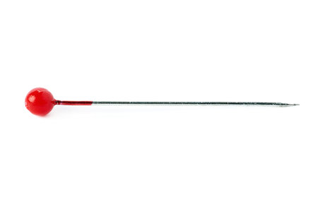 Small sewing push pin needle with red head isolated over the white background