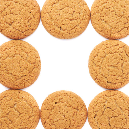 Pile of round cookies with the pieces of chocolate isolated over the white background