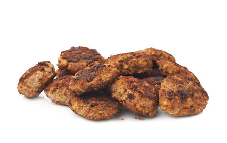 Pile of prepared small hand made cutlets isolated over white background