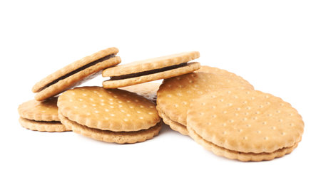 Pile of round cookies with the pieces of chocolate isolated over the white background