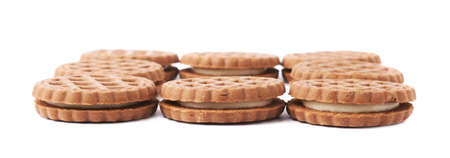 Pile of round cookies with the pieces of chocolate isolated over the white backgroundの写真素材