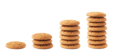 Stack of round cookies with the pieces of chocolate isolated over the white backgroundの写真素材