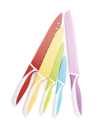 Pile of steel kitchen knives isolated over the white backgroundの写真素材