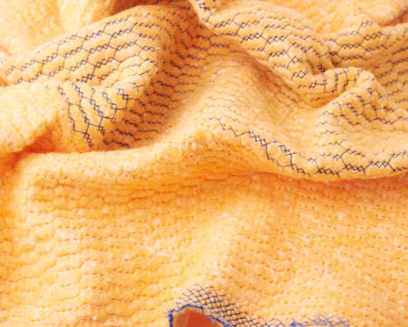 Crumpled yellow towel rag texture as background backdropの写真素材