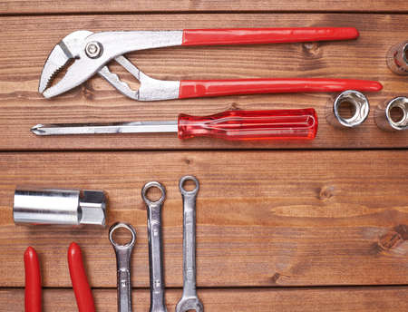 Set of different work tools on wooden brown surfaceの写真素材