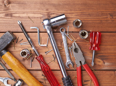 Set of different work tools on wooden brown surface