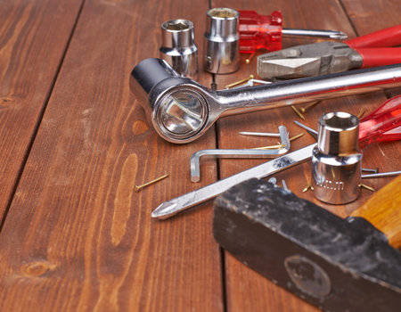 Set of different work tools on wooden brown surface