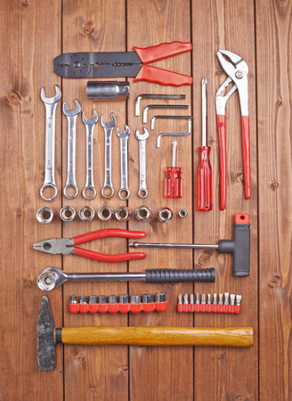 Set of different work tools on wooden brown surface