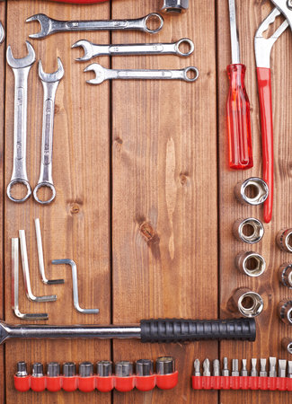 Set of different work tools on wooden brown surface