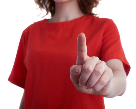 Young woman in casual clothes over white isolated background pointing,showing direction or pushing button, people conceptの写真素材